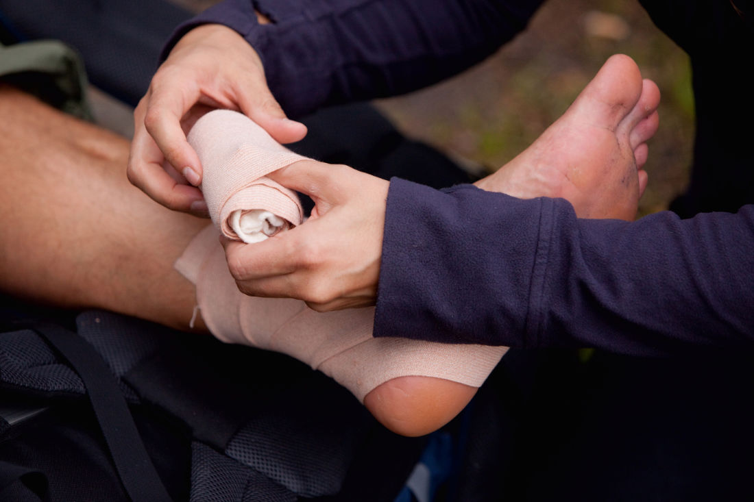 A leg tensor bandage being applied outdoors